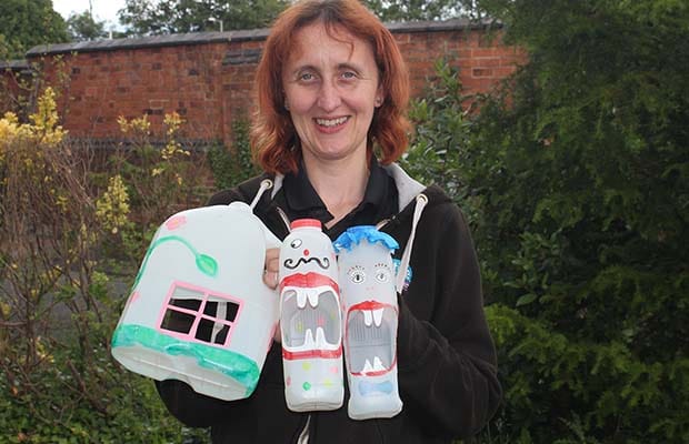 Ruth Piddington with some of the milk bottle creations