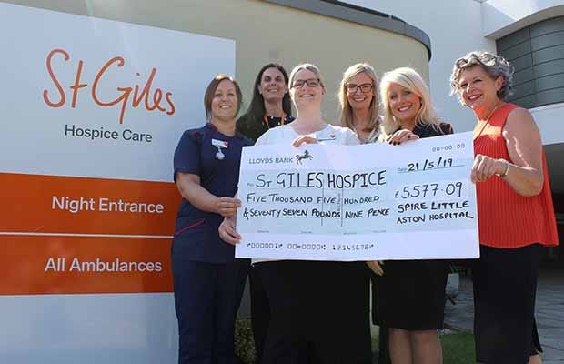 The cheque is handed over to St Giles Hospice
