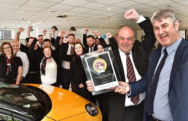 Staff at Bristol Street Motors Lichfield celebrate the award with Peter Hope (right) from Vauxhall Motors Ltd