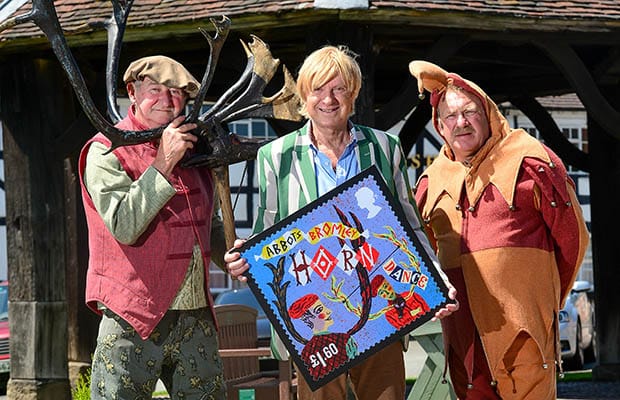 Michael Fabricant (centre) with Jeff Bradbury and Jester Terry Bailey with one of the new stamp designs