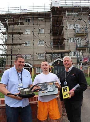 Bromford’s Paul Bradley with resident Conner Moore and Novus’ Adrian Elsby with some of the donated items outside Edgeworth House