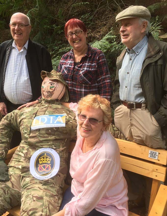 Syd the scarecrow with members of the Lichfield District Tourism Association on the new bench