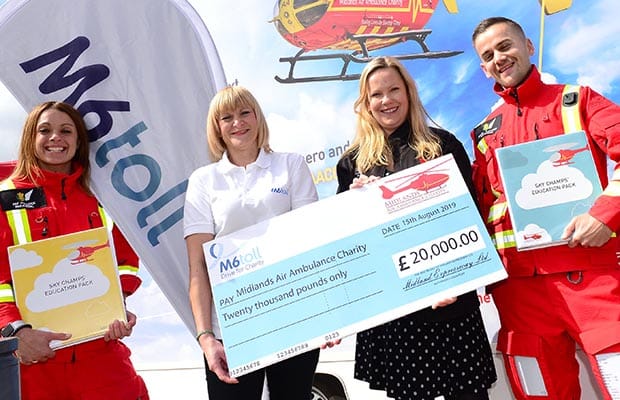 The cheque being handed over to the Midlands Air Ambulance Charity