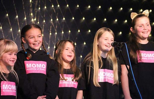 Students performing in a Momo Academy of Drama show