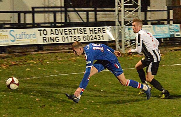 Liam Kirton battles for the ball against Stafford Rangers