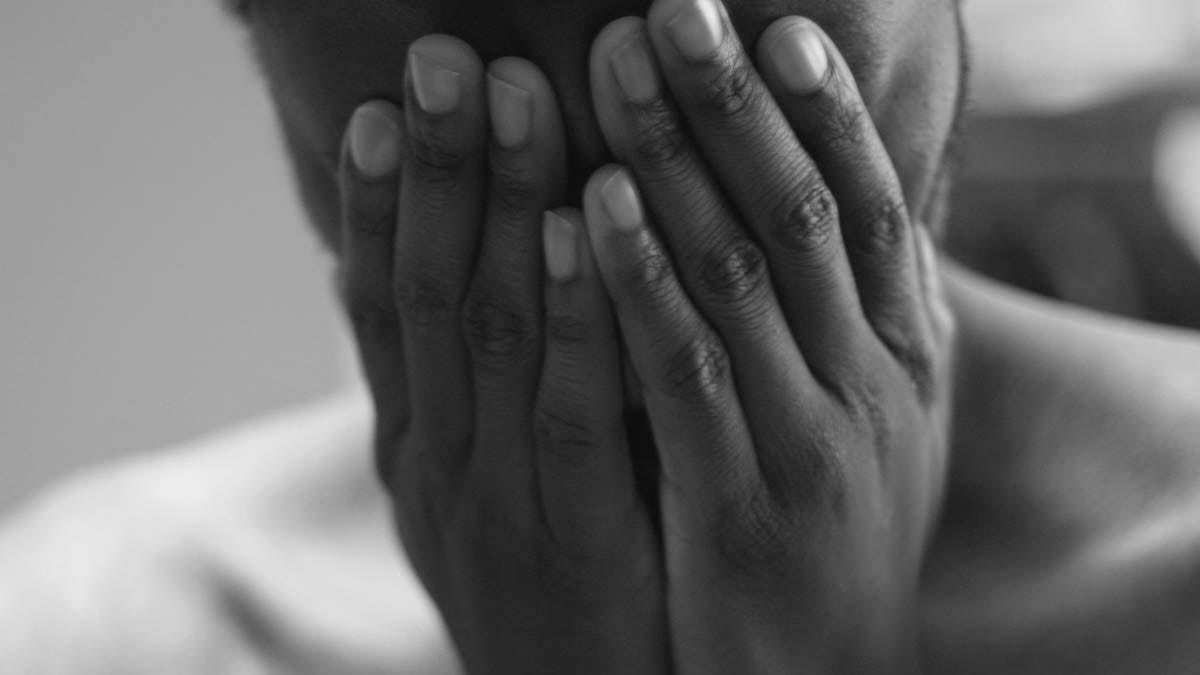 Person covering their eyes