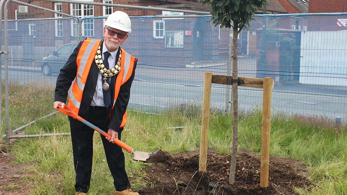Cllr Joseph Powell planting a tree on the former Lichfield police station site