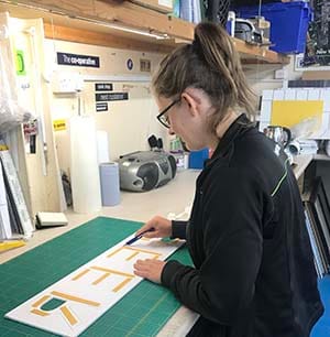 Sophie Mead preparing signage for a Central England Co-op project