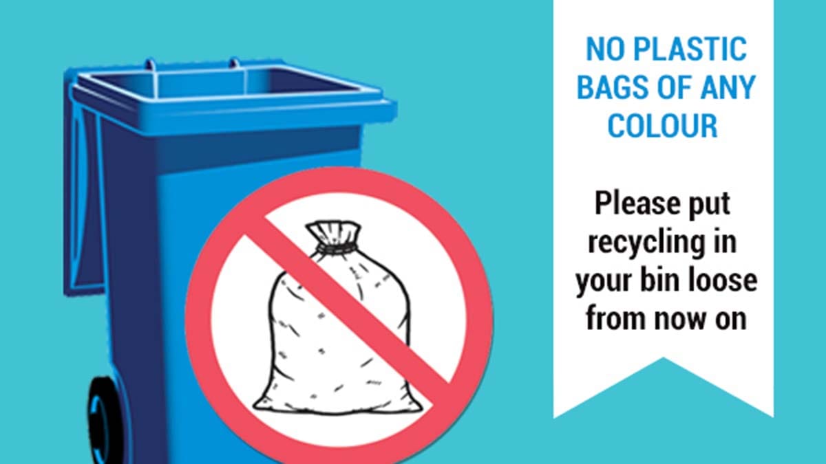 One of the stickers being placed on blue bins