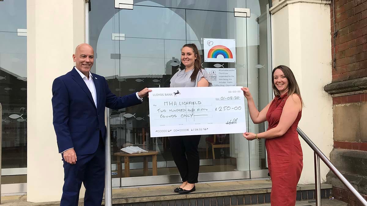 Caroline Bruno (centre) receives the grant from Martin Lahert and Hannah Burgess of Bluebird Care