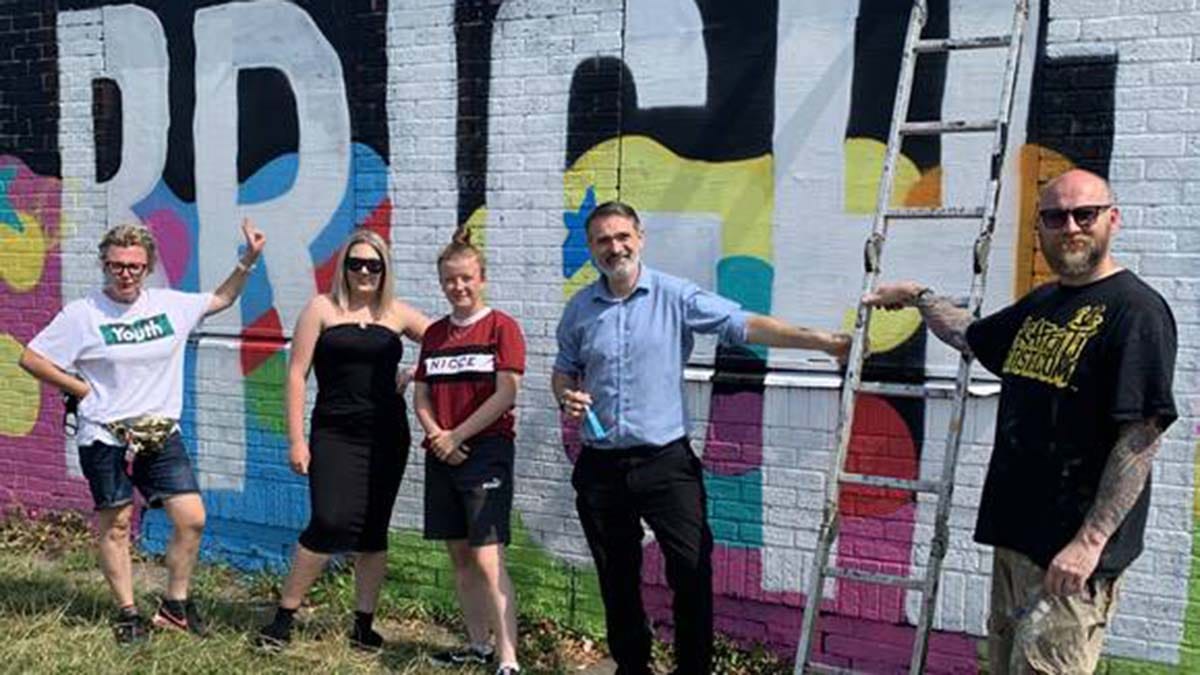 Cllr Darren Ennis with some of those who helped to create the mural