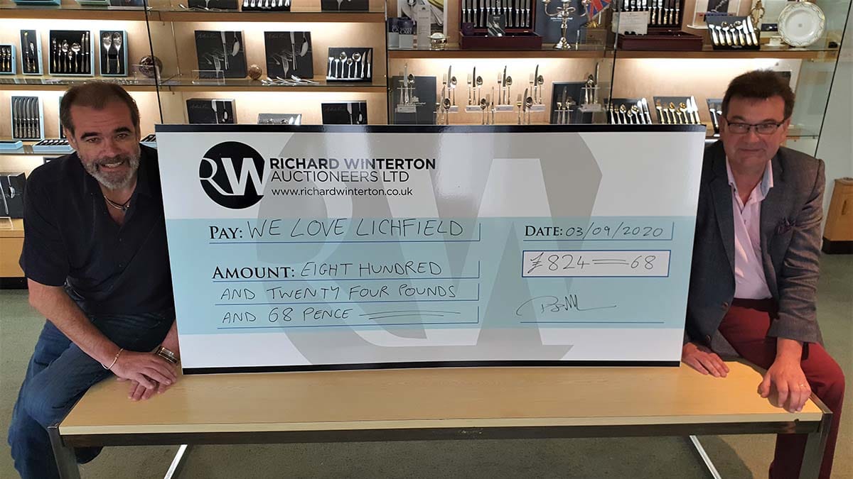 Simon Price (left) receiving the cheque from Richard Winterton