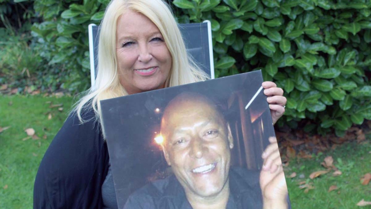 Gill Henley with a picture of her husband Charlie