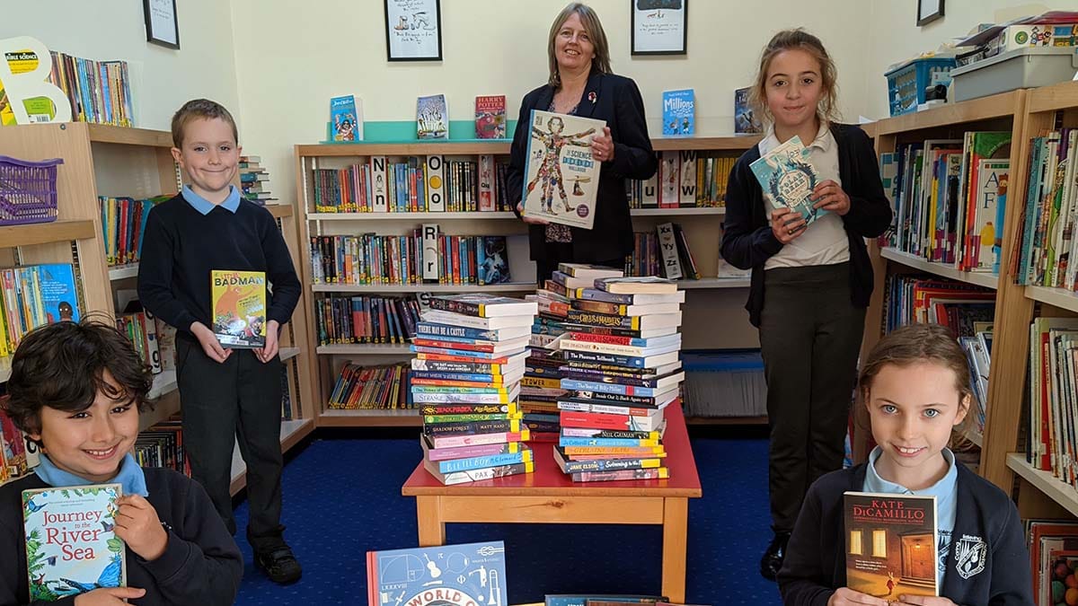 Scotch Orchard headteacher Jo Bishop with pupils celebrating the success of the virtual book drive
