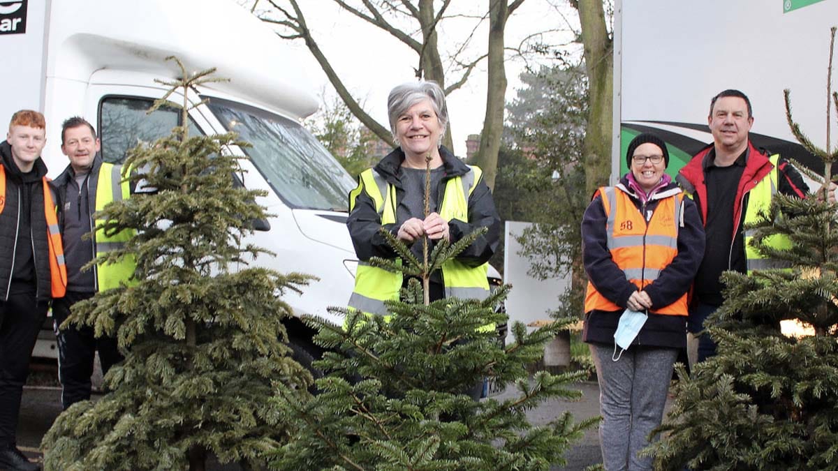 Treecycle volunteers with some of the Christmas trees they collected
