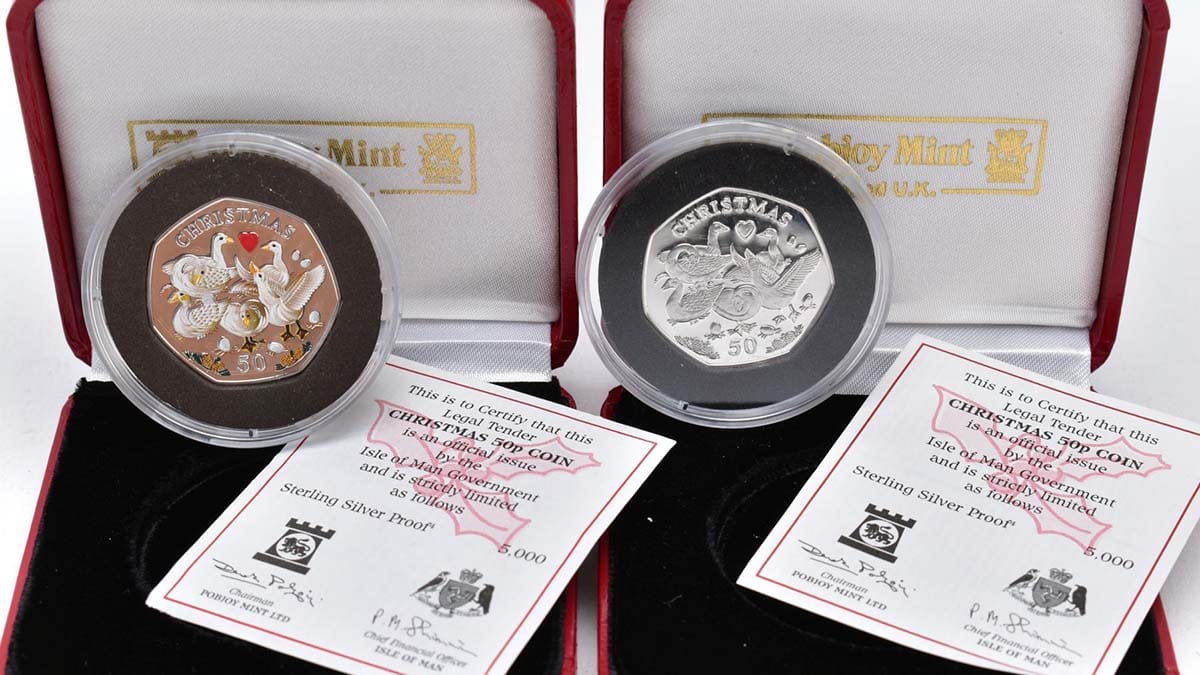 A boxed pair of Christmas 50p silver proofs which sold for £800