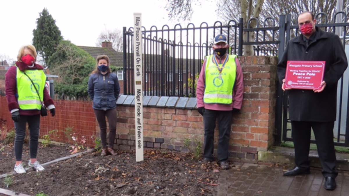 A Peace Pole being planted as part of the pilot project in Warwickshire