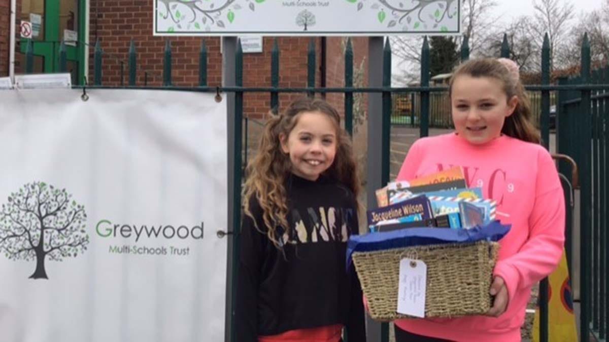 Piper Quinn and Isabelle Delaney from Henry Chadwick Primary School with one of the book hampers