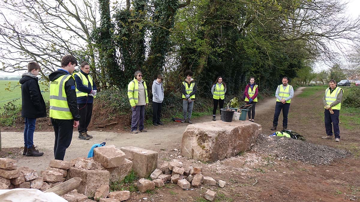 Duke of Edinburgh volunteers holding a minute's silence alongside the Lichfield Canal