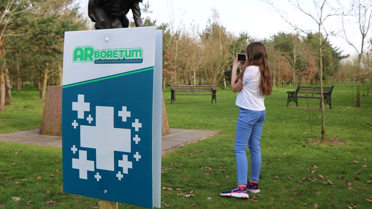 A visitor using the app at the National Memorial Arboretum
