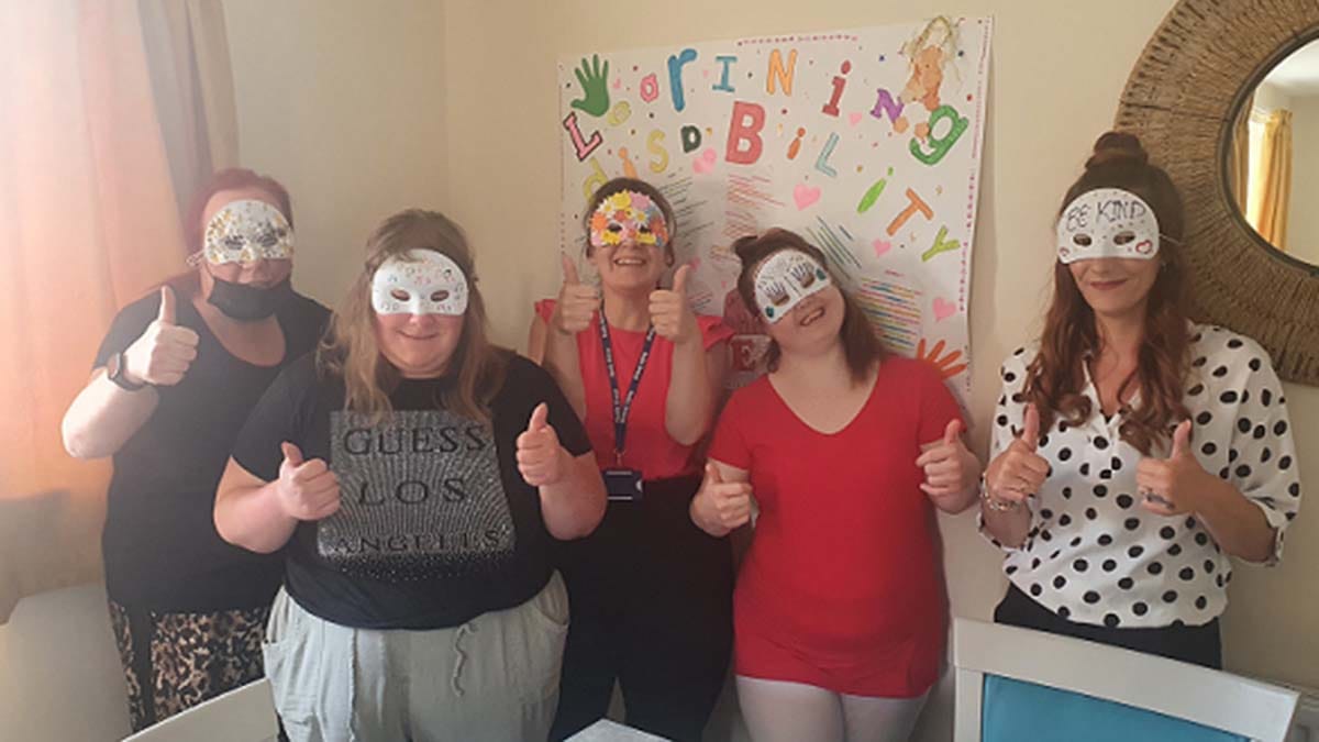 Staff and service users with their masks