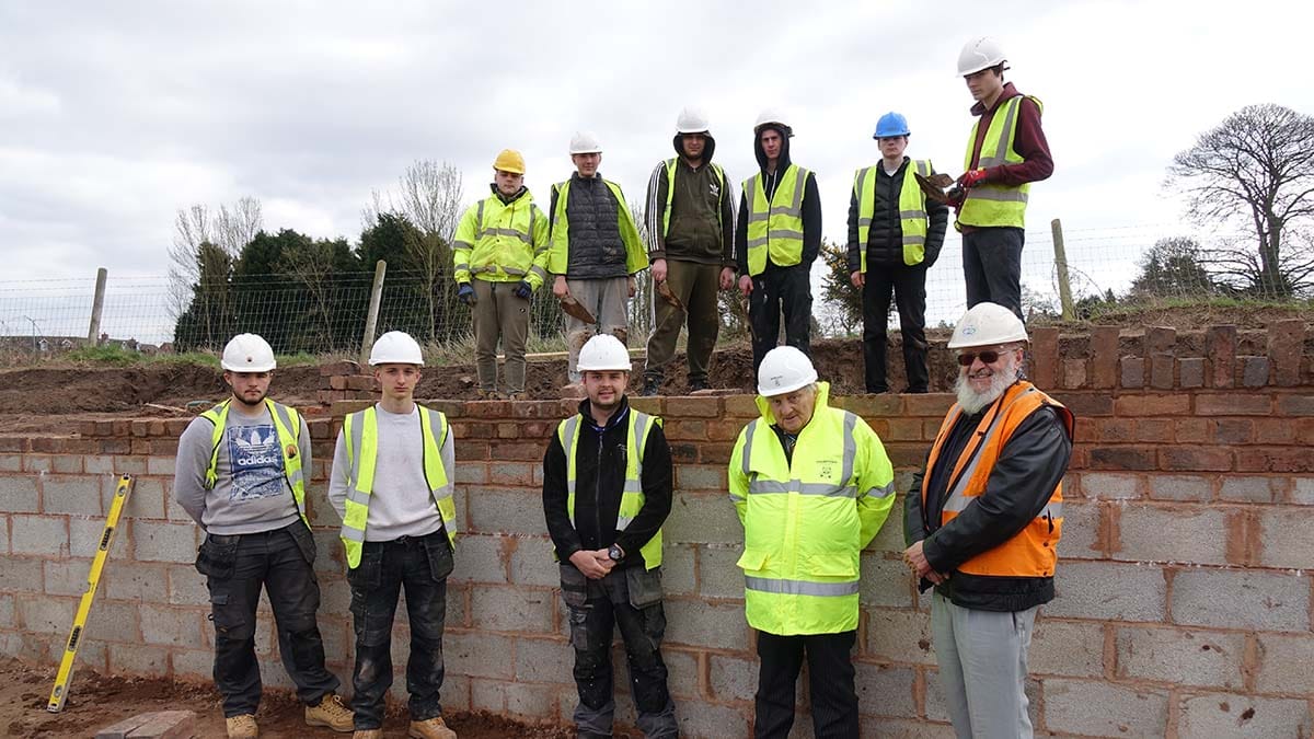 Noel Sweeney (front, second right) on a visit to Lichfield and Hatherton Canals Restoration Trust's site to meet college students he helped to get work experience