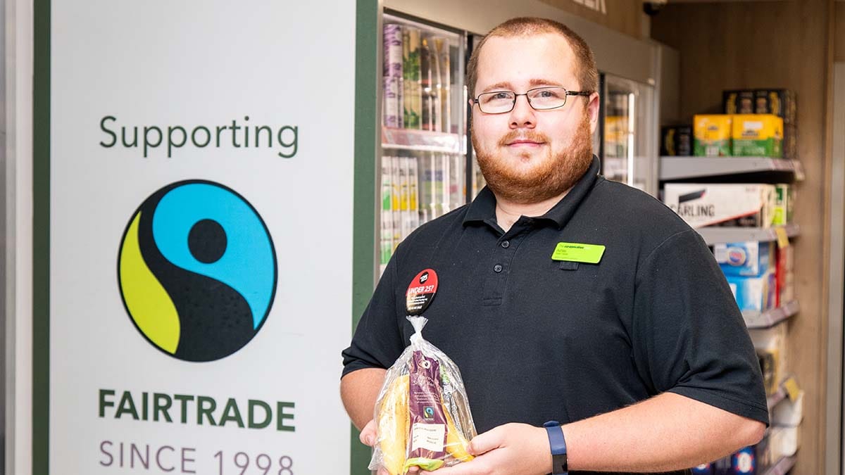 Co-op staff member with Fairtrade bananas