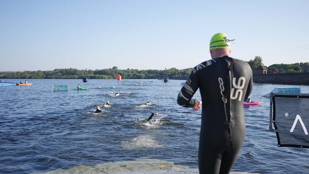 Competitors heading into the water for the swim at Chasewater