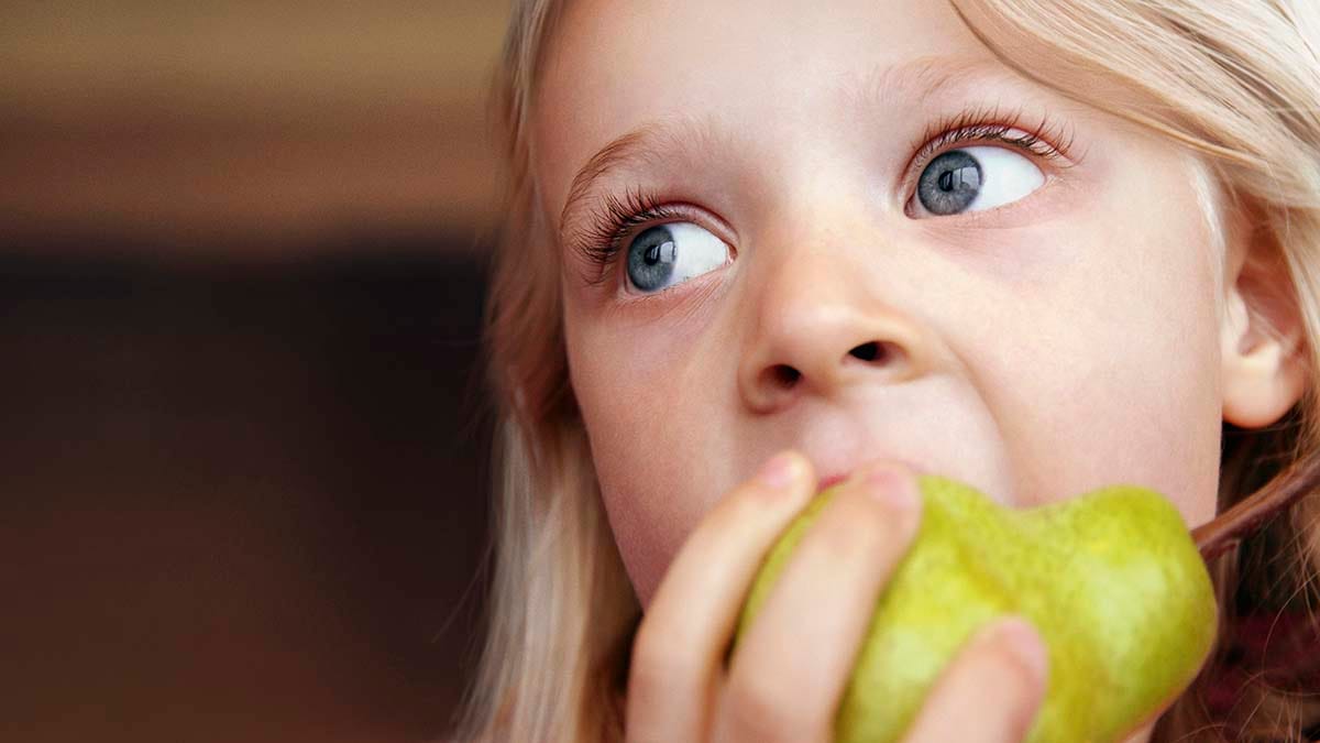 Girl eating fruit