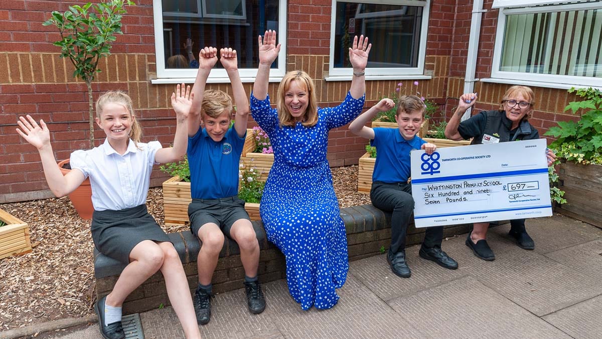 Headteacher Nichola Leeson and Co-op store manager Sheila Villers with pupils at Whittington Primary School