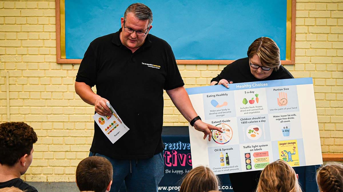 James Knight and Amanda Gallie talking to children about making healthy choices