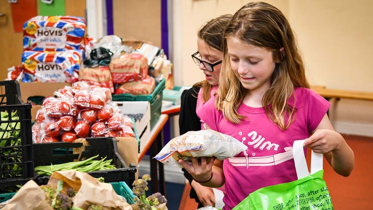 Children picking up items from the pop-up food market supplied by FareShare Midlands and funded thanks to Central England Co-op shoppers
