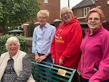 Ken's partner Marilyn Masters with members of the Lichfield District Tourism Association at the bench with the new plaque