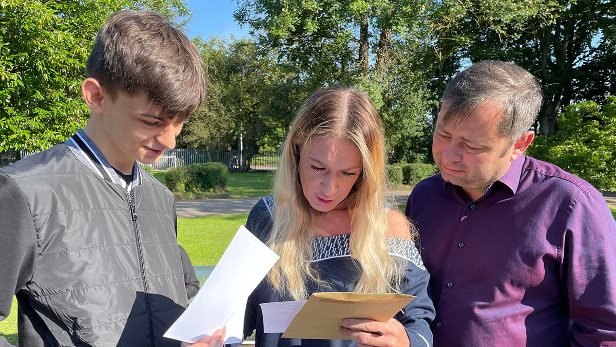 Christian Carr receiving his GCSE results with parents Karl and Gayle