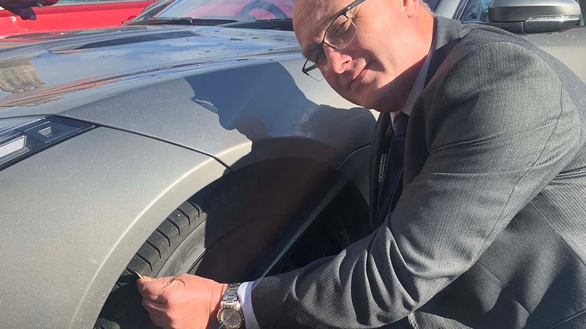 Cllr David Williams checking his tyre tread depth