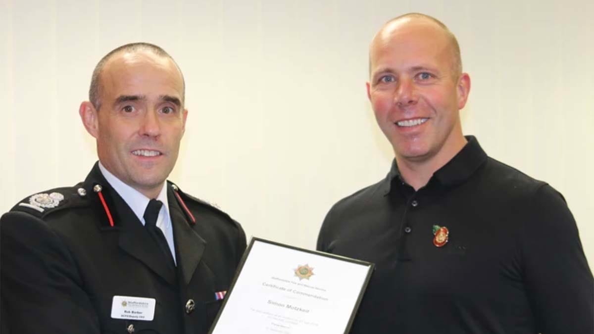 Chief Fire Officer Rob Barber presenting Simon Motzkeit with his award