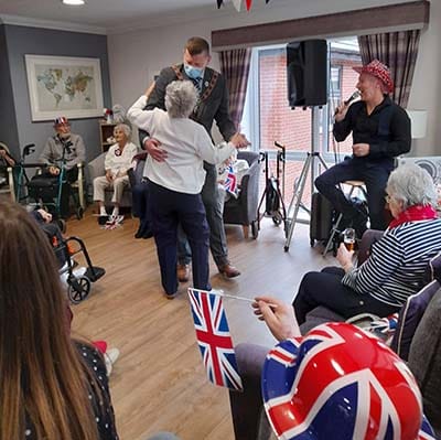 A resident at The Spires dancing with the Deputy Mayor of Lichfield