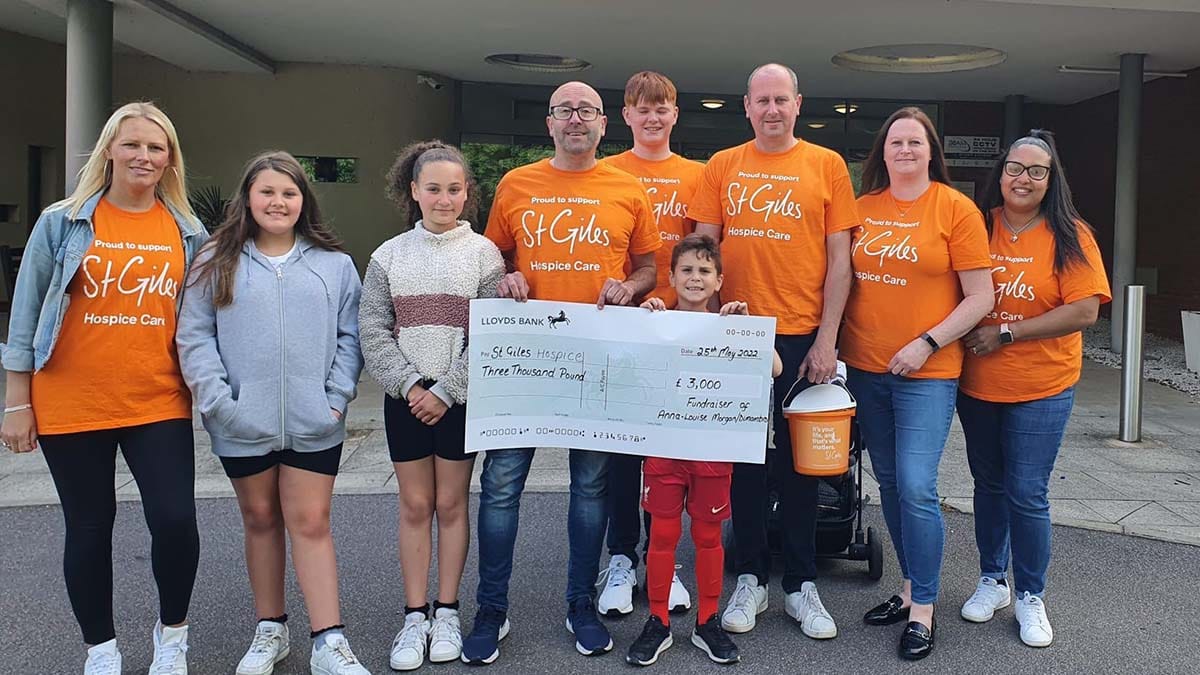 Matt Morgan with his family and friends donating to St Giles Hospice