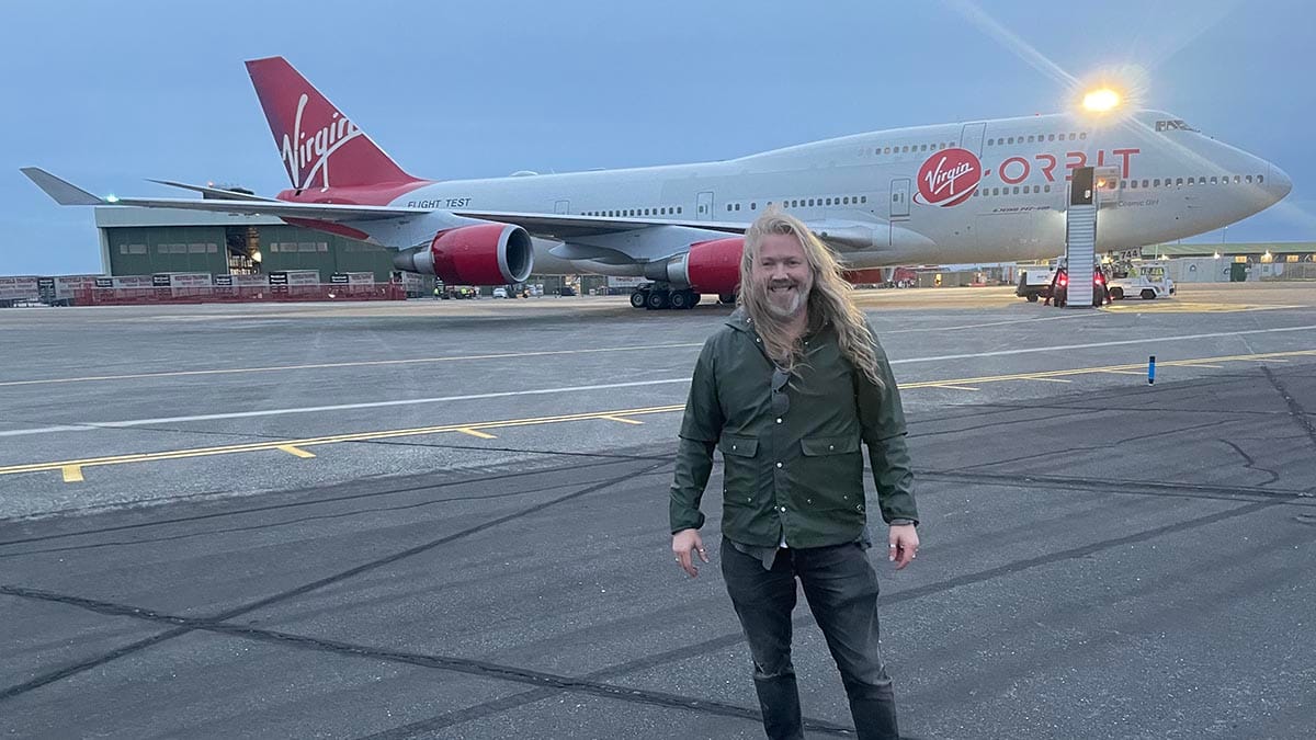 Keaton Stone in front of a Virgin Orbit aircraft