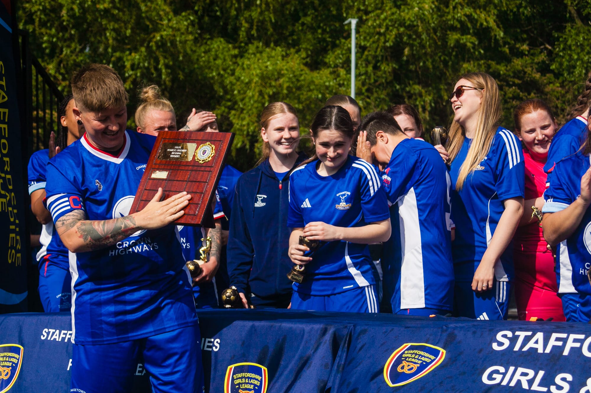 Captain Becky Wood with the SGLFL Premier Division Champions' 'Trophy'