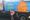 A child stood in front of a food waste collection truck