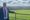 Cllr Anthony Screen stood in front of a field of sheep