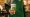 A barista holding a Starbucks coffee cup
