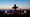 Sunset behind a cross with candles