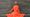 Dancer in orange outfit sat on steps