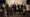 Orchestra holding drinks and instruments