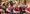 People around the Christmas tree in Santa hats