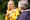 A woman doing sign language for another person