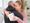 Woman hugging a man holding a memorial gift
