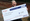 A woman holding a £5,000 winter raffle winner cheque